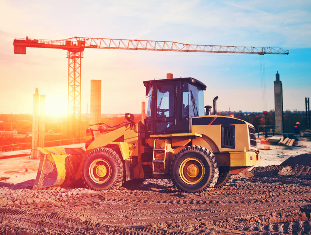 wheel loader construction equipment on a job site at dusk