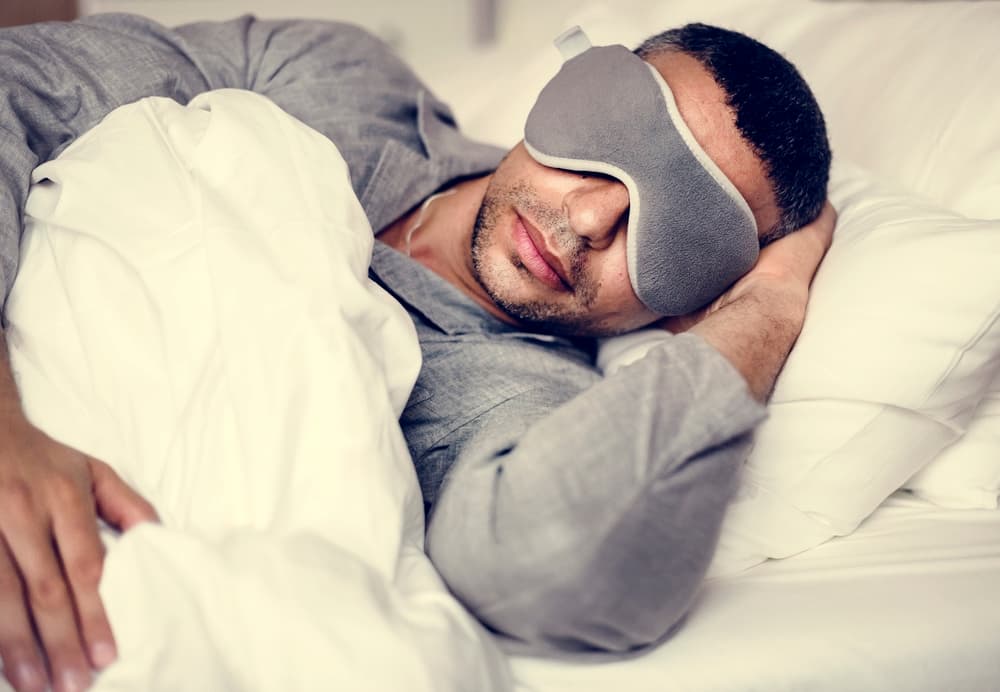 truck driver sleeping in cab with eye mask