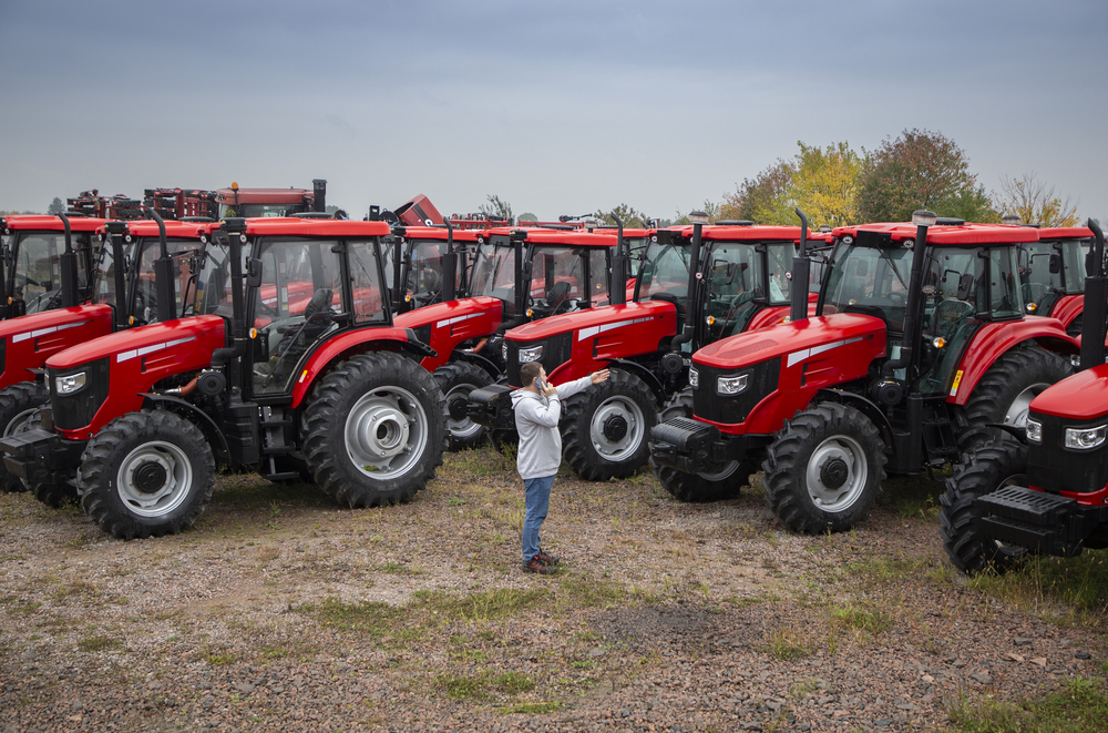 man comparing agricultural equipment