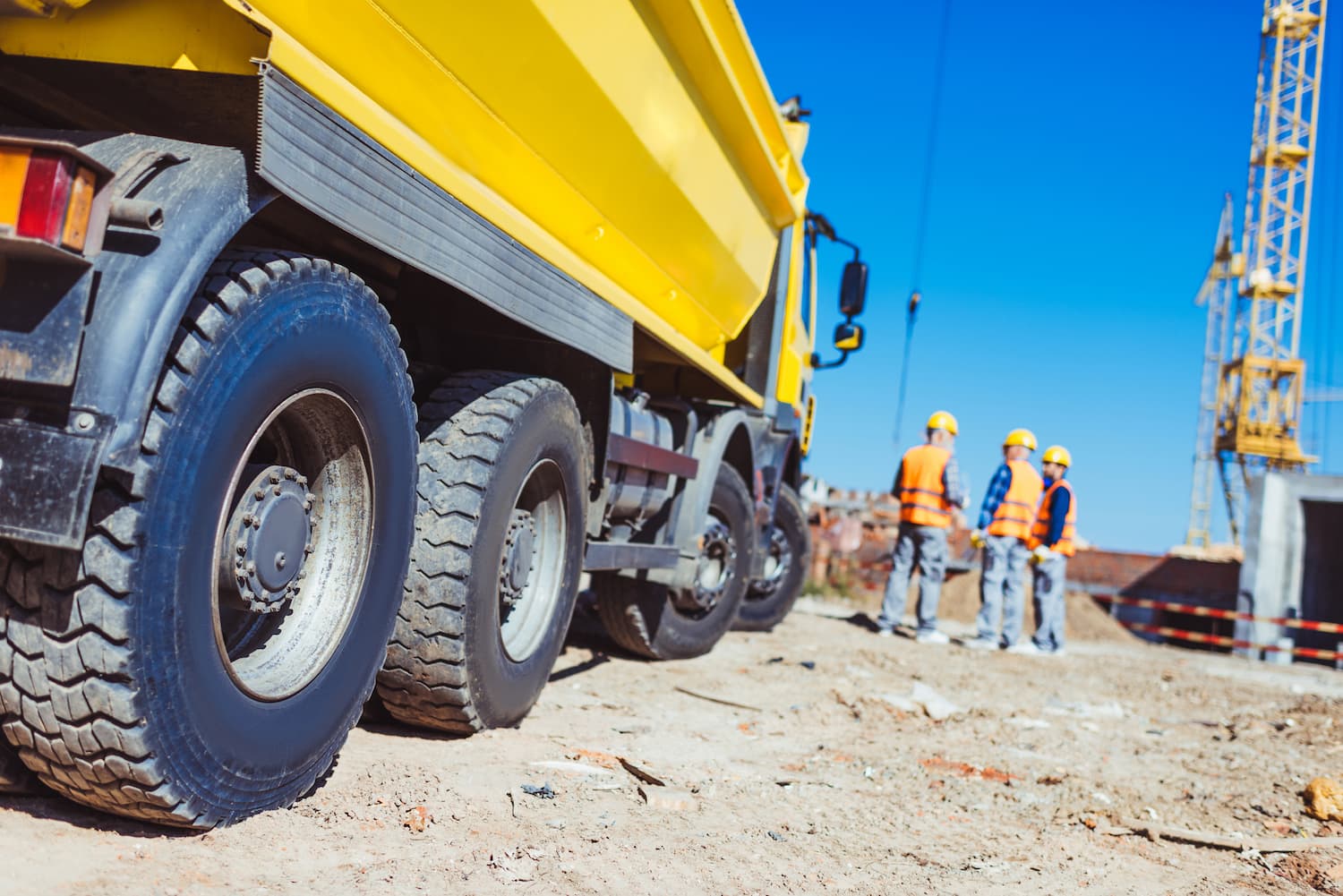 dump truck on construction site with workers
