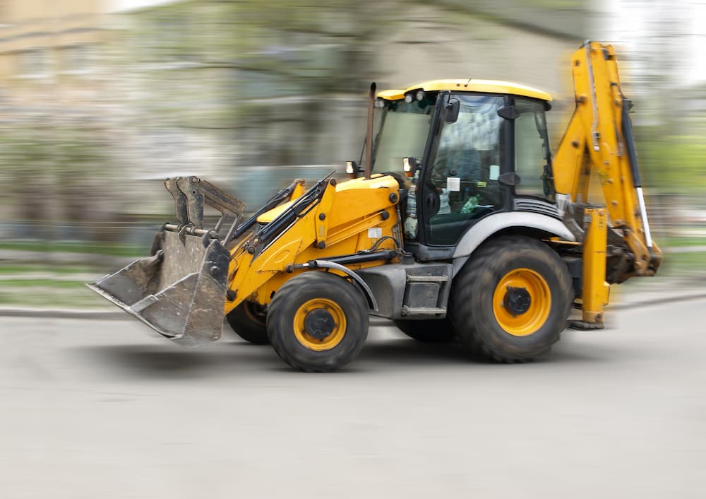 backhoe driving on roads