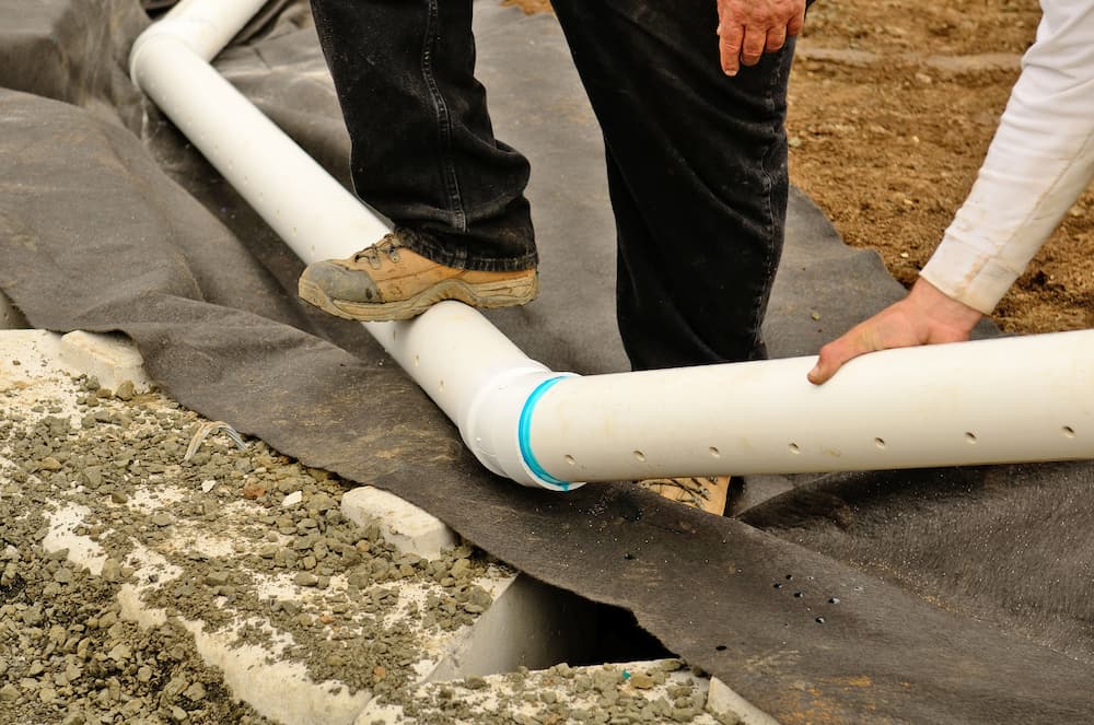 pvc french drain being installed