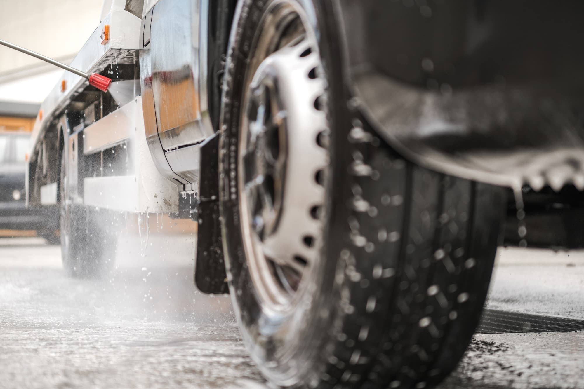 person power washing commercial truck to sell