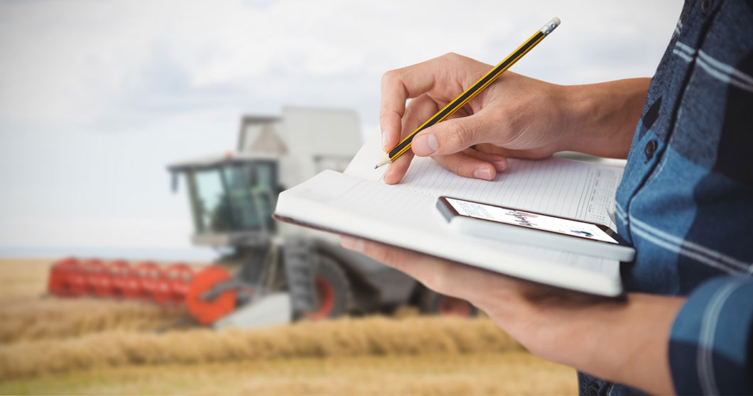 Farm Equipment and Farmer Calculating