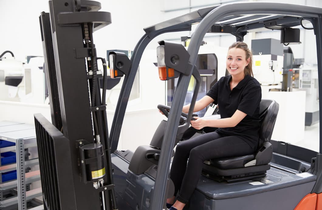 young woman operating a forklift
