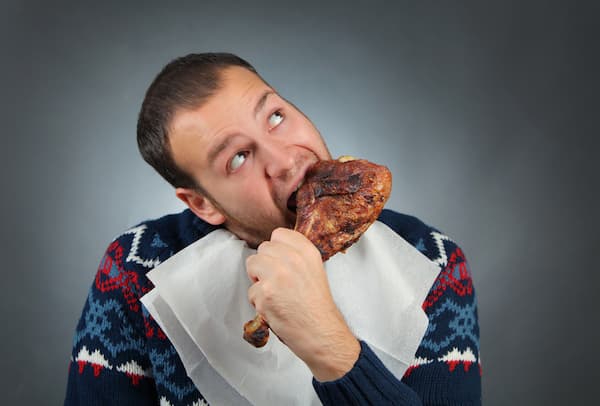 man eating turkey in a sweater