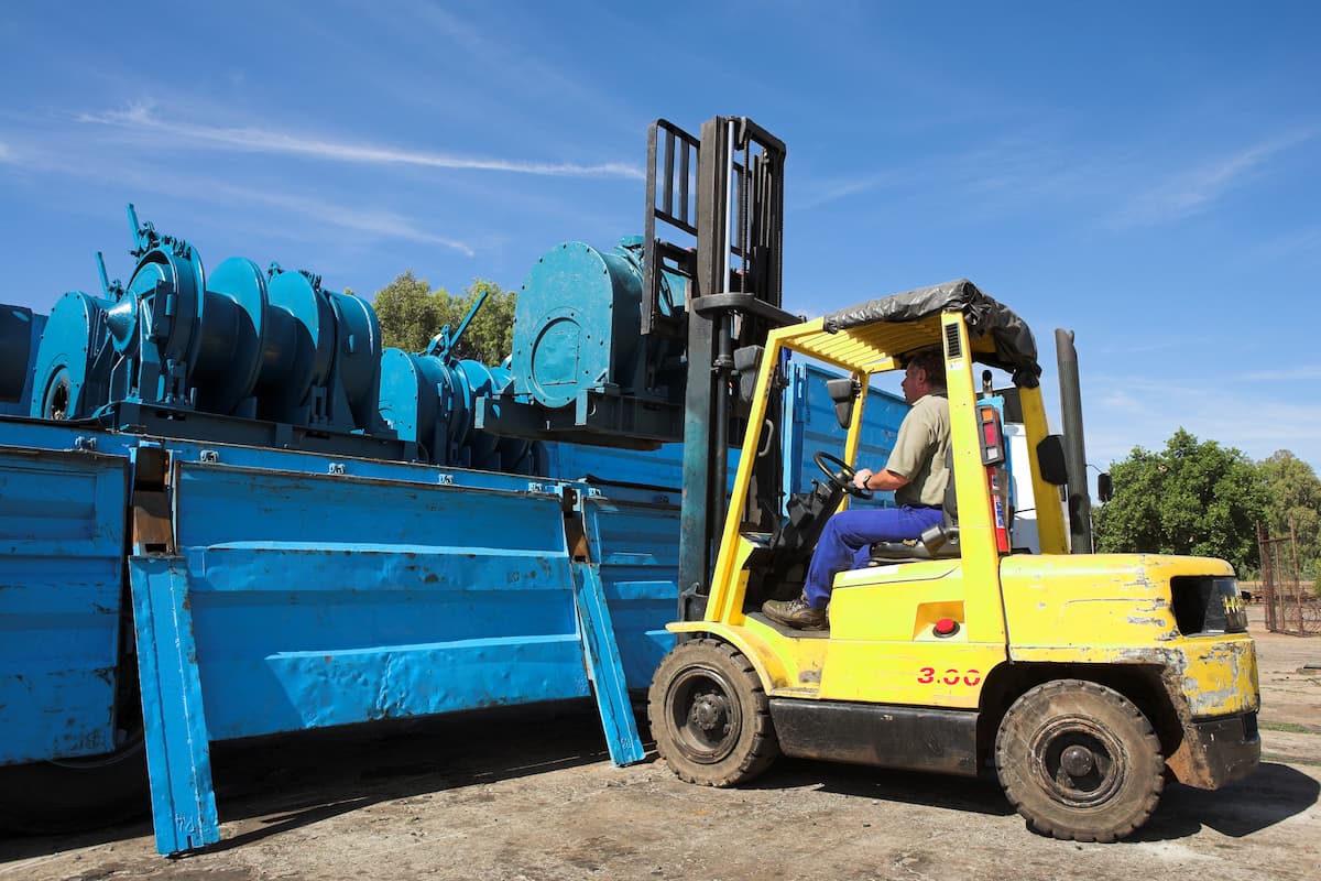 man operating yellow forklift