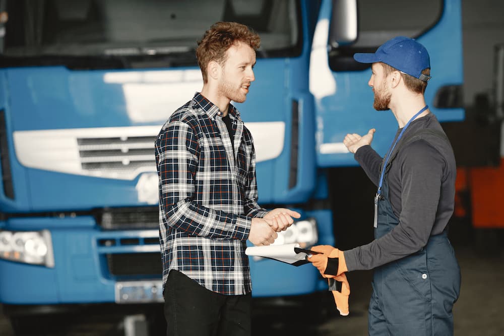 truck driver talking to loader