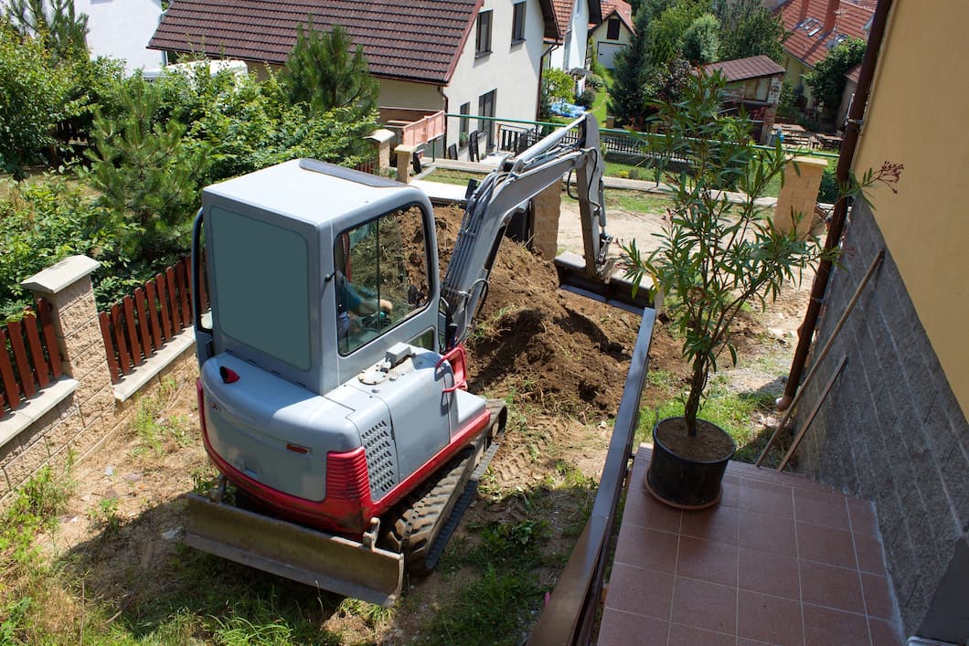 mini excavator working in yard
