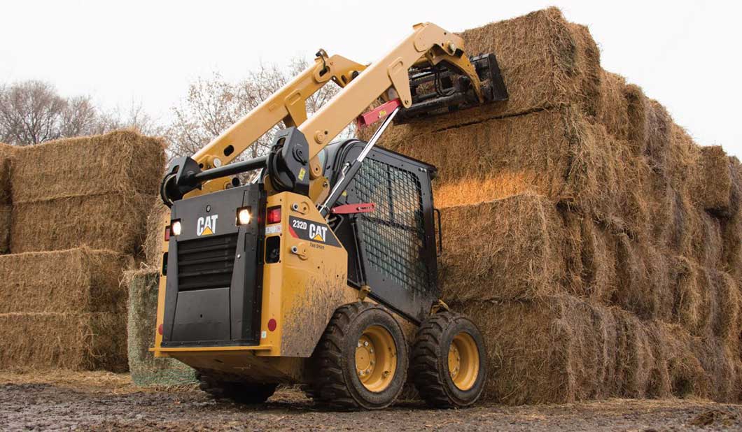 CAT 232D Skid Steer Lifting Hay