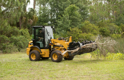 Cat 903D carrying branches